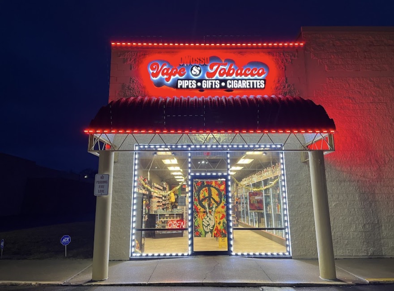 Storefront of Owosso Vape & Tobacco Inc. lit up at night at 1629 E M 21, Owosso, MI 48867